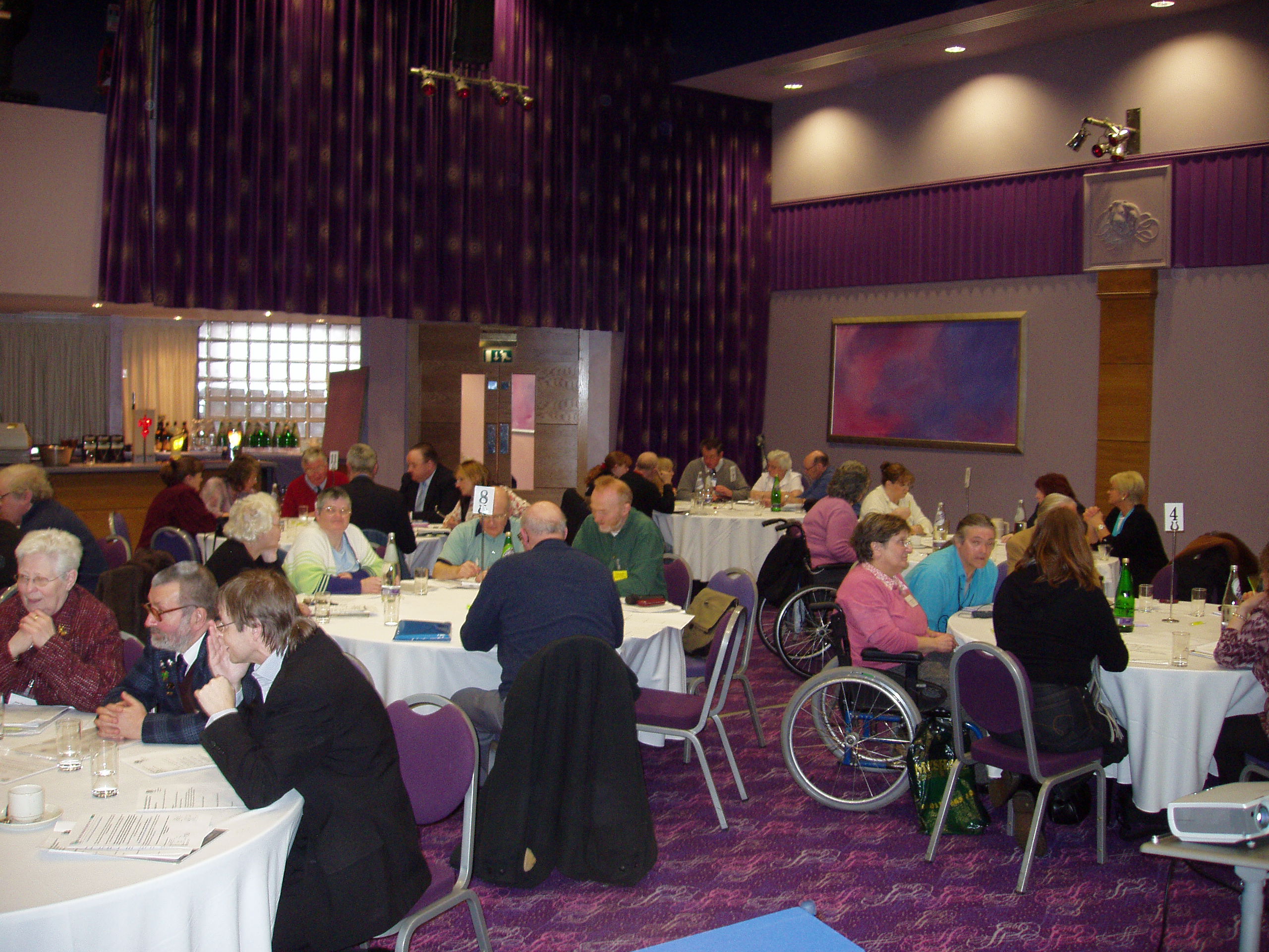 Delegates sitting ar round tables during the conference