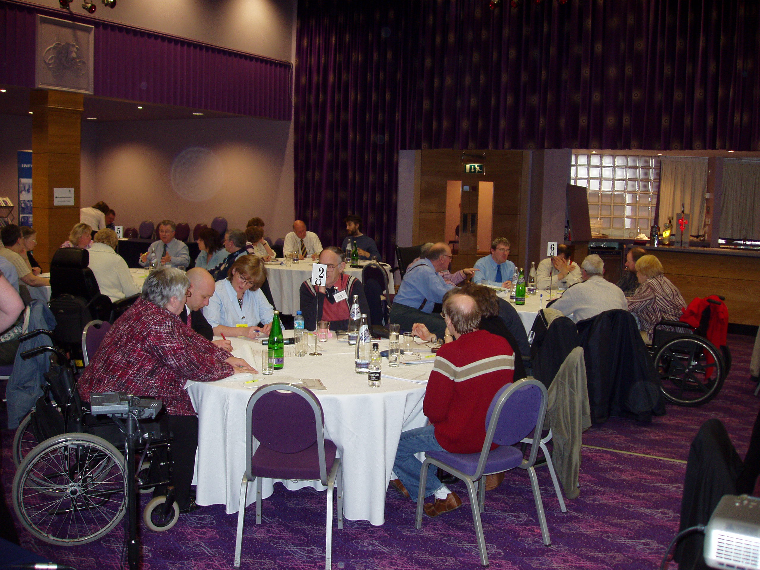 Another view of delegates sitting at round tables during the conference