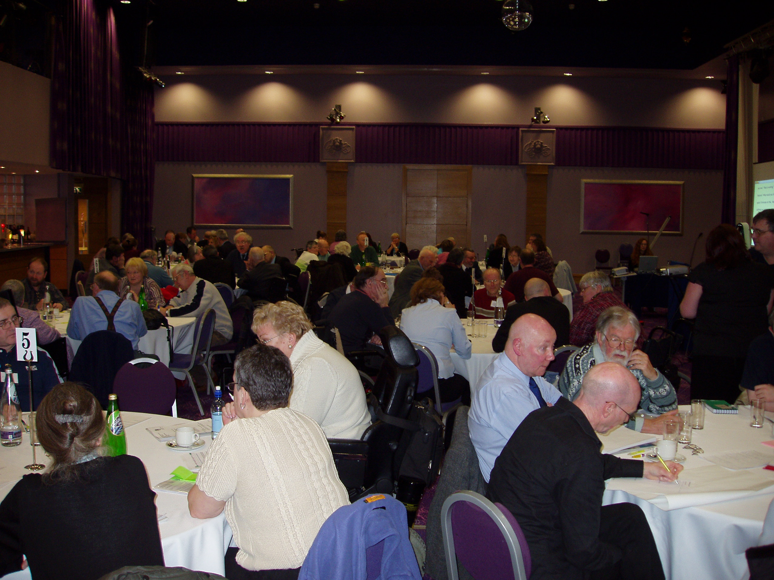 Another view of delegates sitting at round tables during the conference