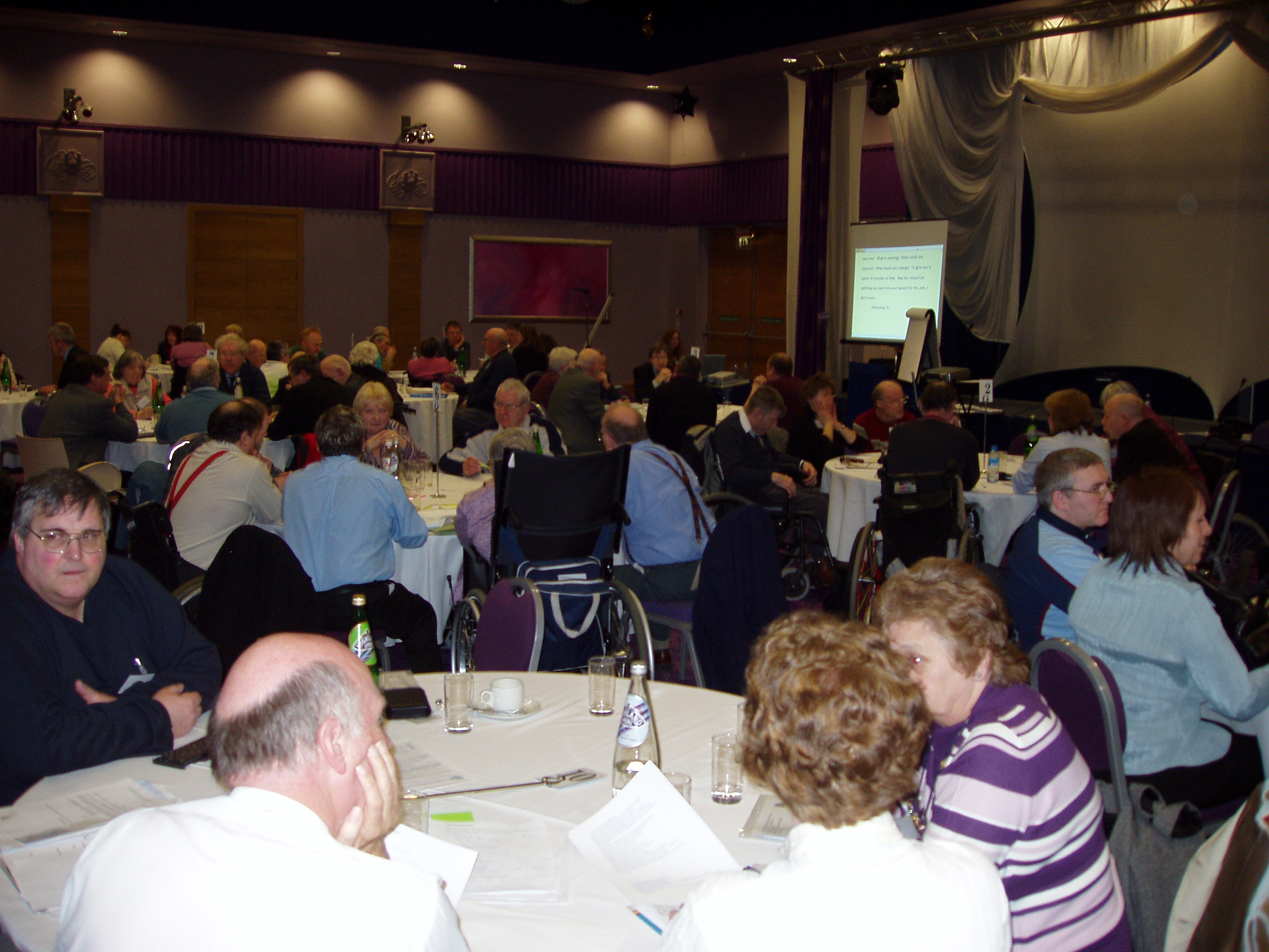 Another view of delegates sitting at round tables during the conference